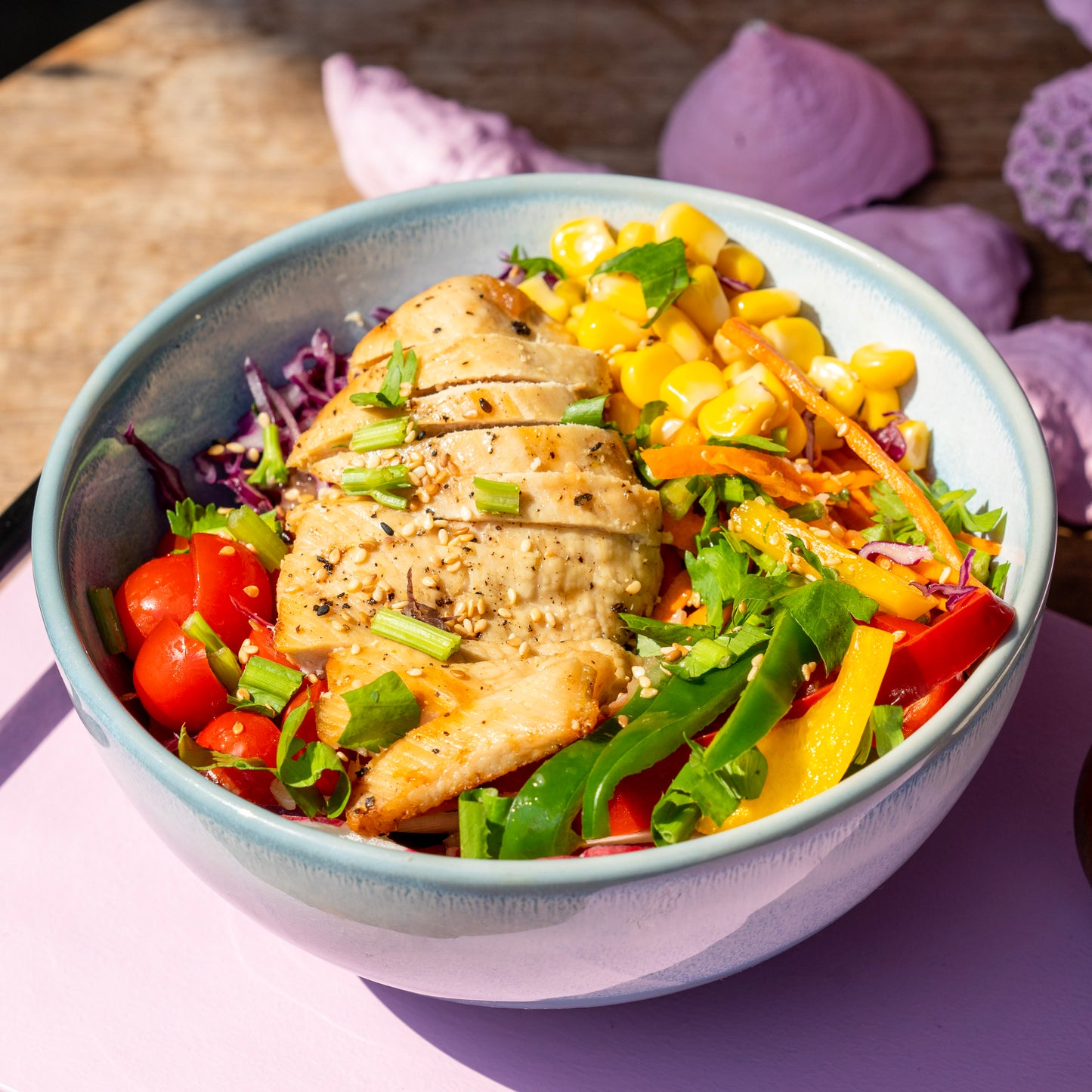 Vibrant Rainbow Chicken Salad bowl with grilled chicken breast and fresh vegetables at YESH! Tribe | Eat & Vibe in Hoi An